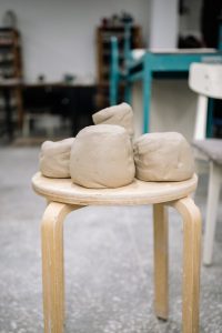 Blocks of Clay Lying on Wooden Stool